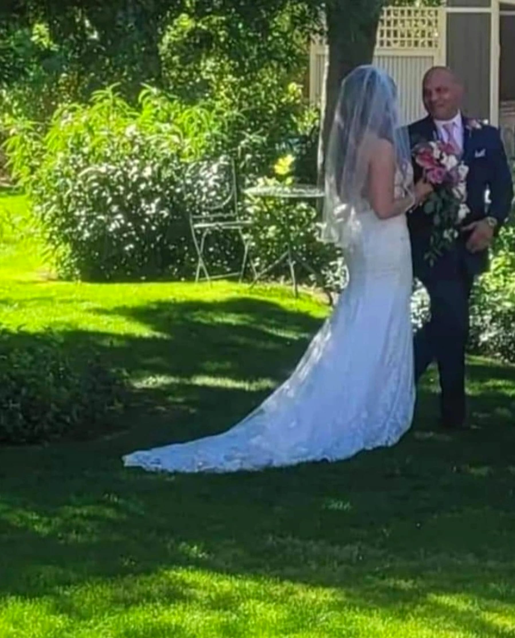 A bride walking the aisle through the garden.